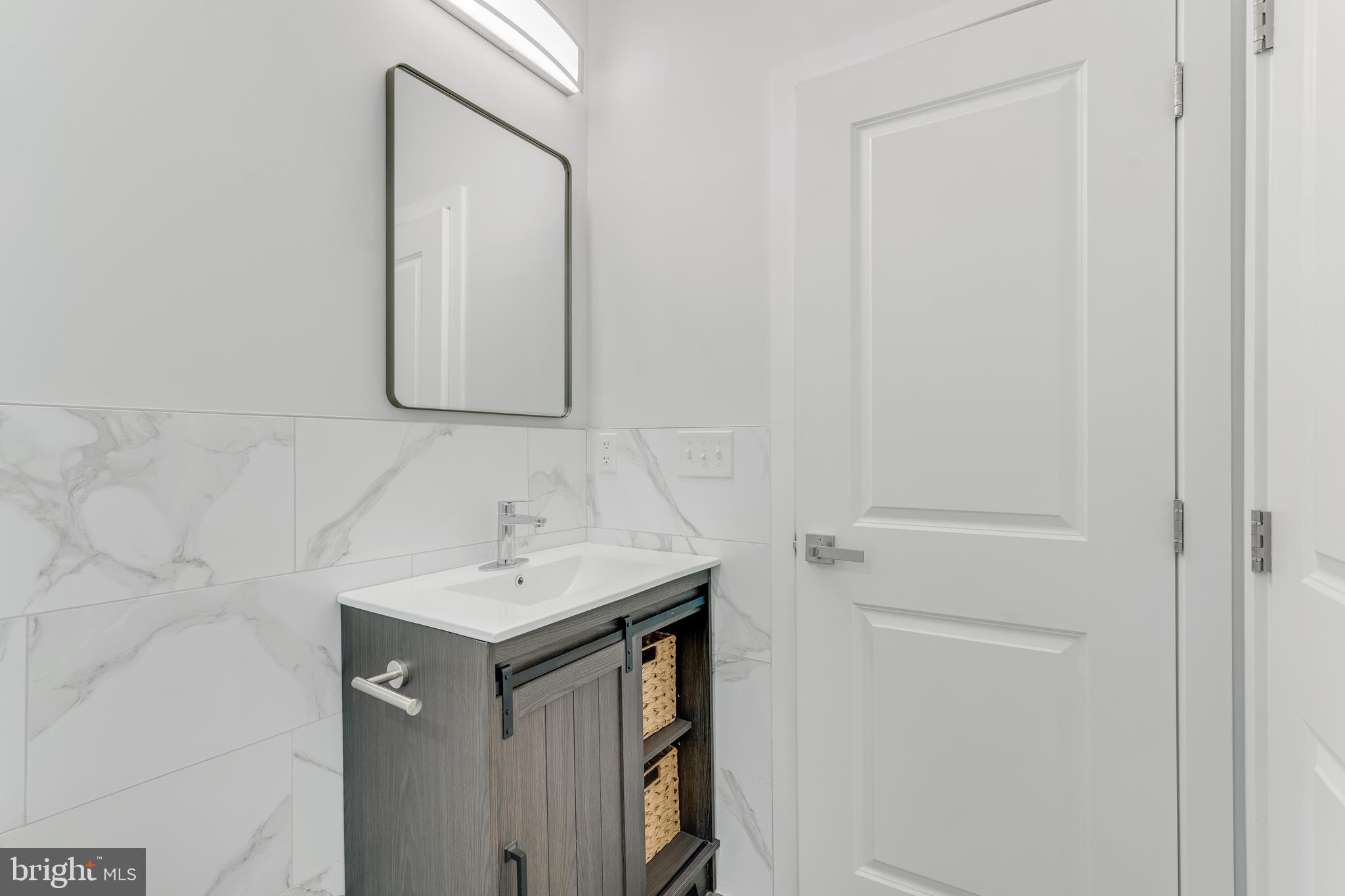 1243 West Westmoreland Street, Unit 2 Philadelphia, PA 19140 - Photo 17 of 18 a bathroom with a sink and a mirror