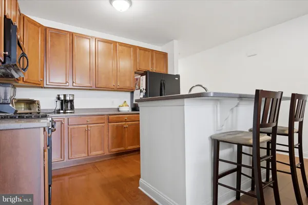 a kitchen with stainless steel appliances granite countertop a refrigerator sink and microwave