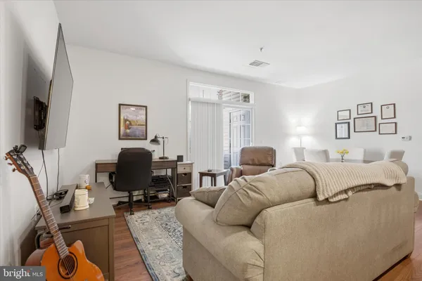 a living room with furniture a couch and a flat screen tv