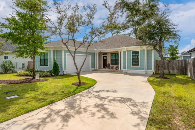 a house that has a tree in front of a house