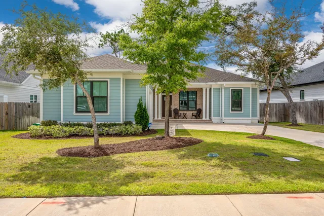 a view of a house with swimming pool and a yard
