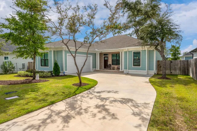 a house that has a tree in front of a house