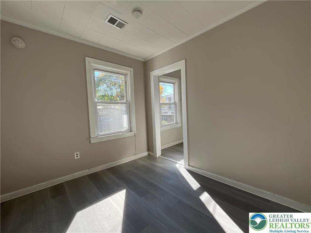 25 South 13th Street, Unit 2 Easton, PA 18042 - Photo 3 of 16 an empty room with wooden floor and windows