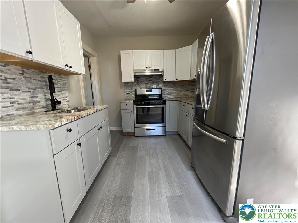 25 South 13th Street, Unit 2 Easton, PA 18042 - Photo 9 of 16 a kitchen with stainless steel appliances a refrigerator sink and cabinets