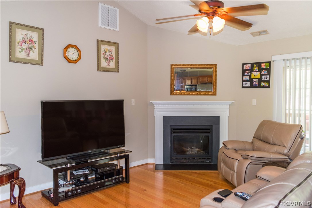 11620 Hillside Road Chester, VA 23831 - Photo 5 of 30 a living room with furniture a flat screen tv and a fireplace