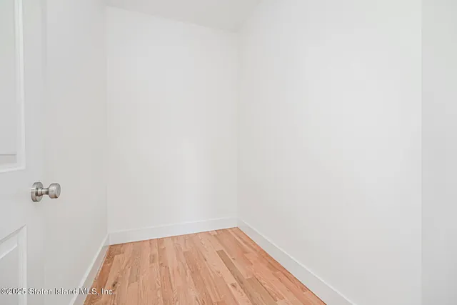 a view of a small space with wooden floor