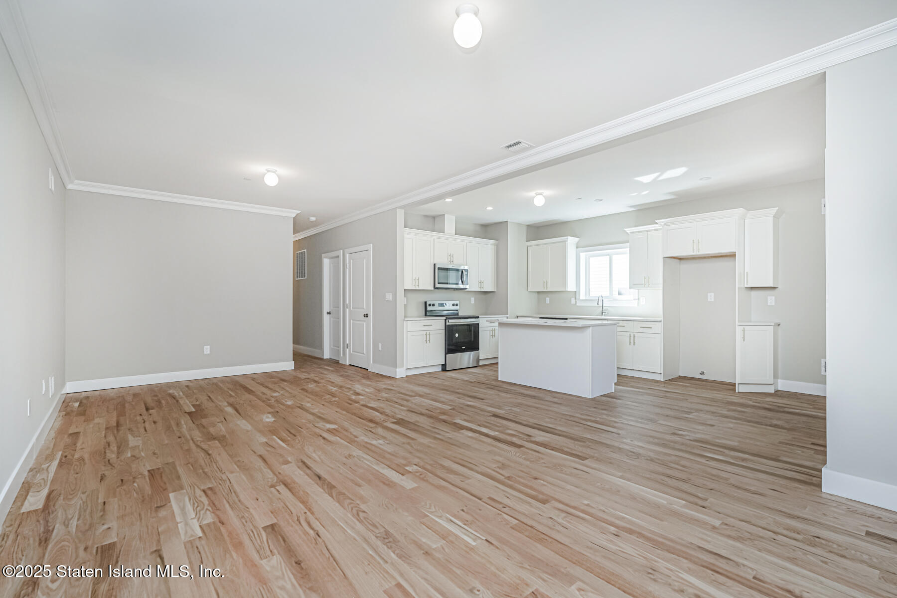 291 Rensselaer Avenue Staten Island, NY 10312 - Photo 18 of 38 a view of a kitchen with wooden floor and a window