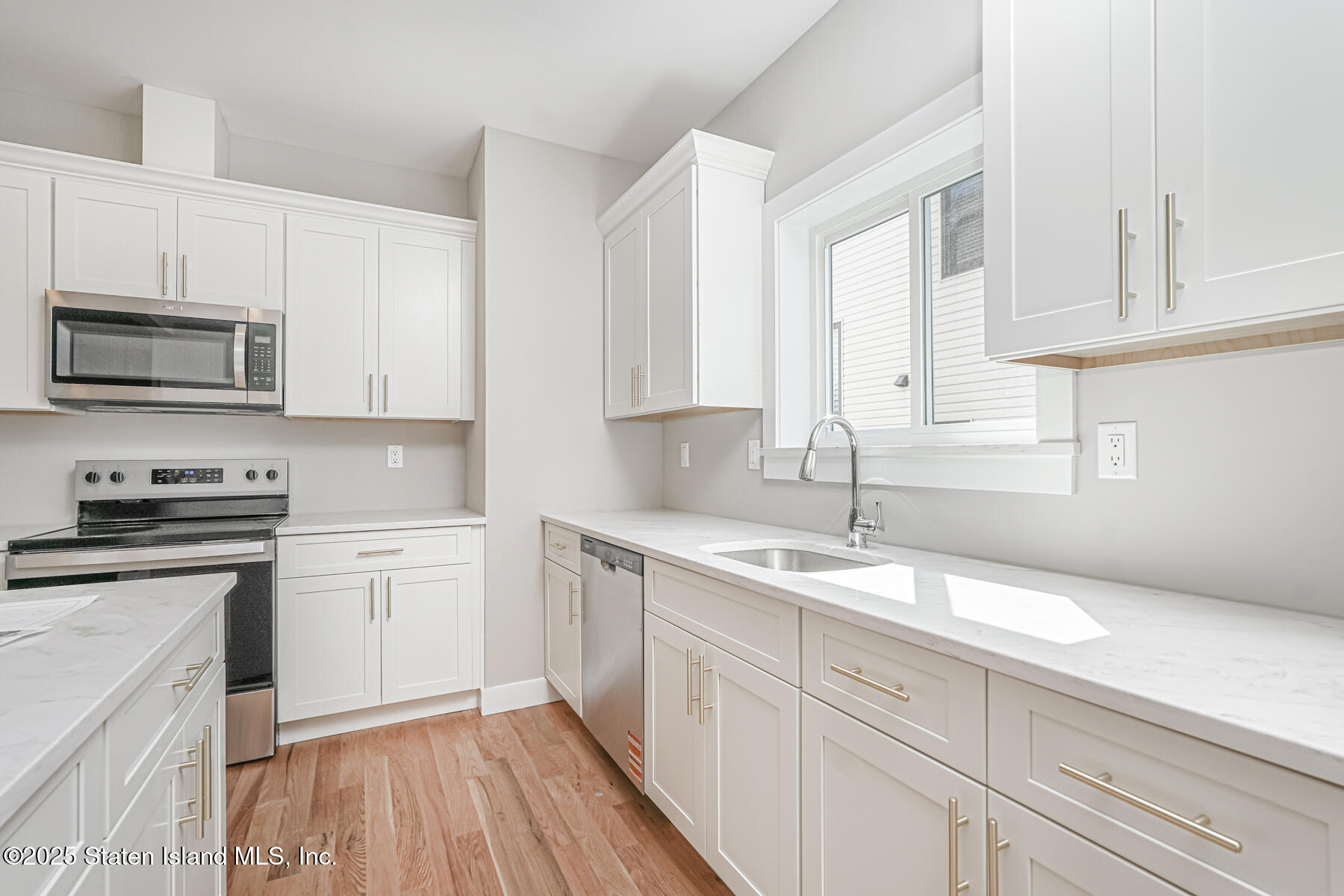 291 Rensselaer Avenue Staten Island, NY 10312 - Photo 22 of 38 a kitchen with granite countertop cabinets stainless steel appliances a sink and wooden floor