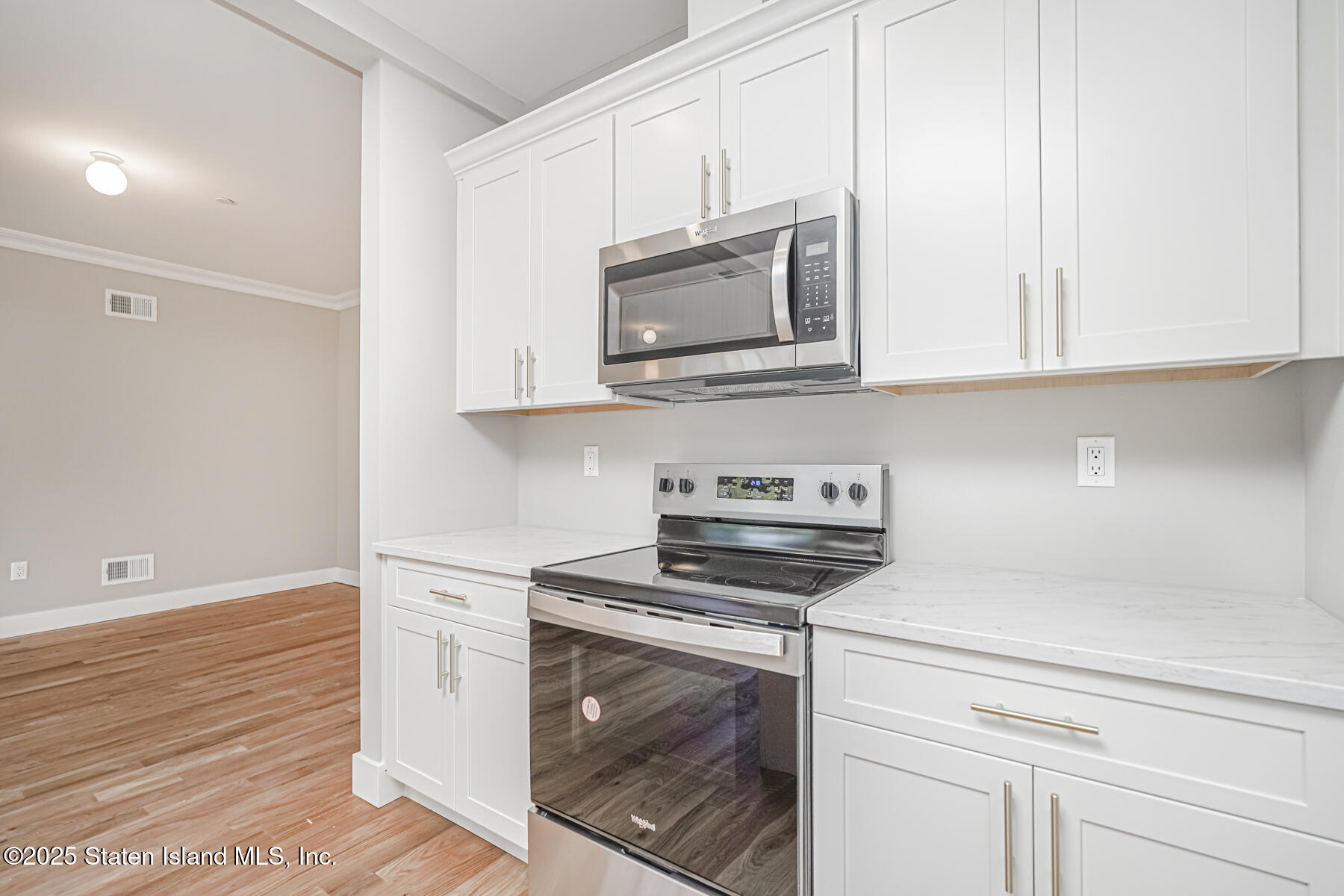 291 Rensselaer Avenue Staten Island, NY 10312 - Photo 23 of 38 a kitchen with stainless steel appliances granite countertop white cabinets and a stove top oven