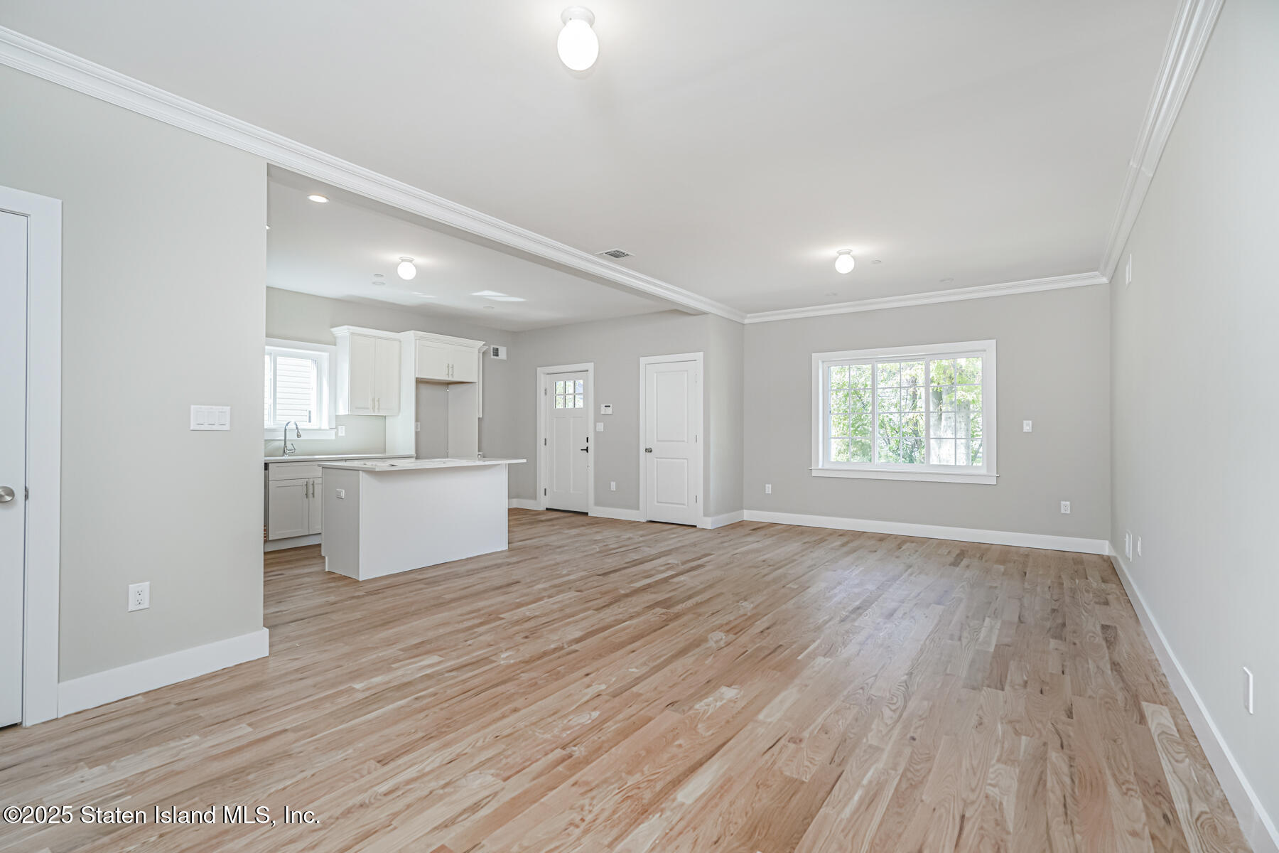 291 Rensselaer Avenue Staten Island, NY 10312 - Photo 24 of 38 an empty room with wooden floor and windows