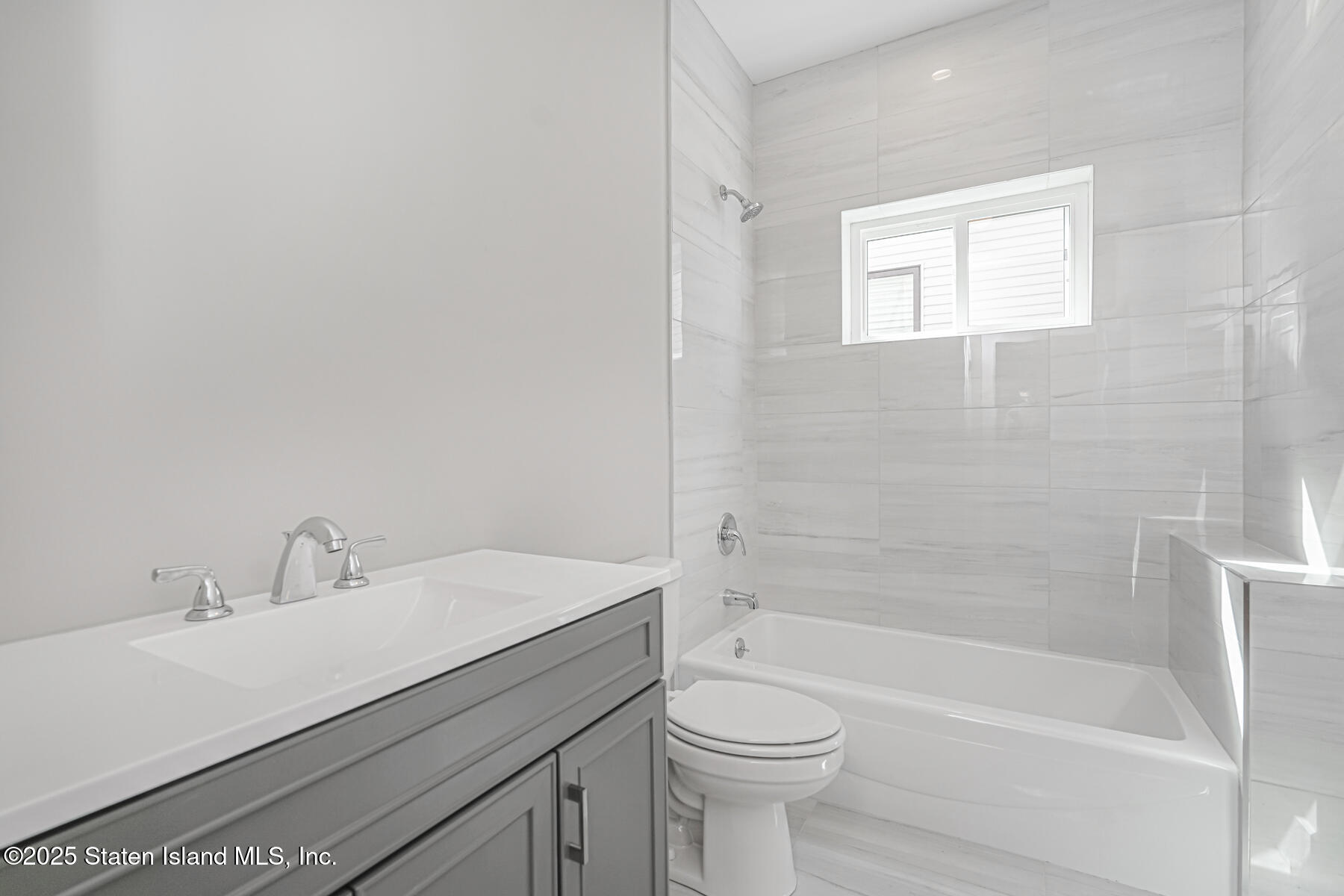 291 Rensselaer Avenue Staten Island, NY 10312 - Photo 25 of 38 a bathroom with a sink a toilet and shower