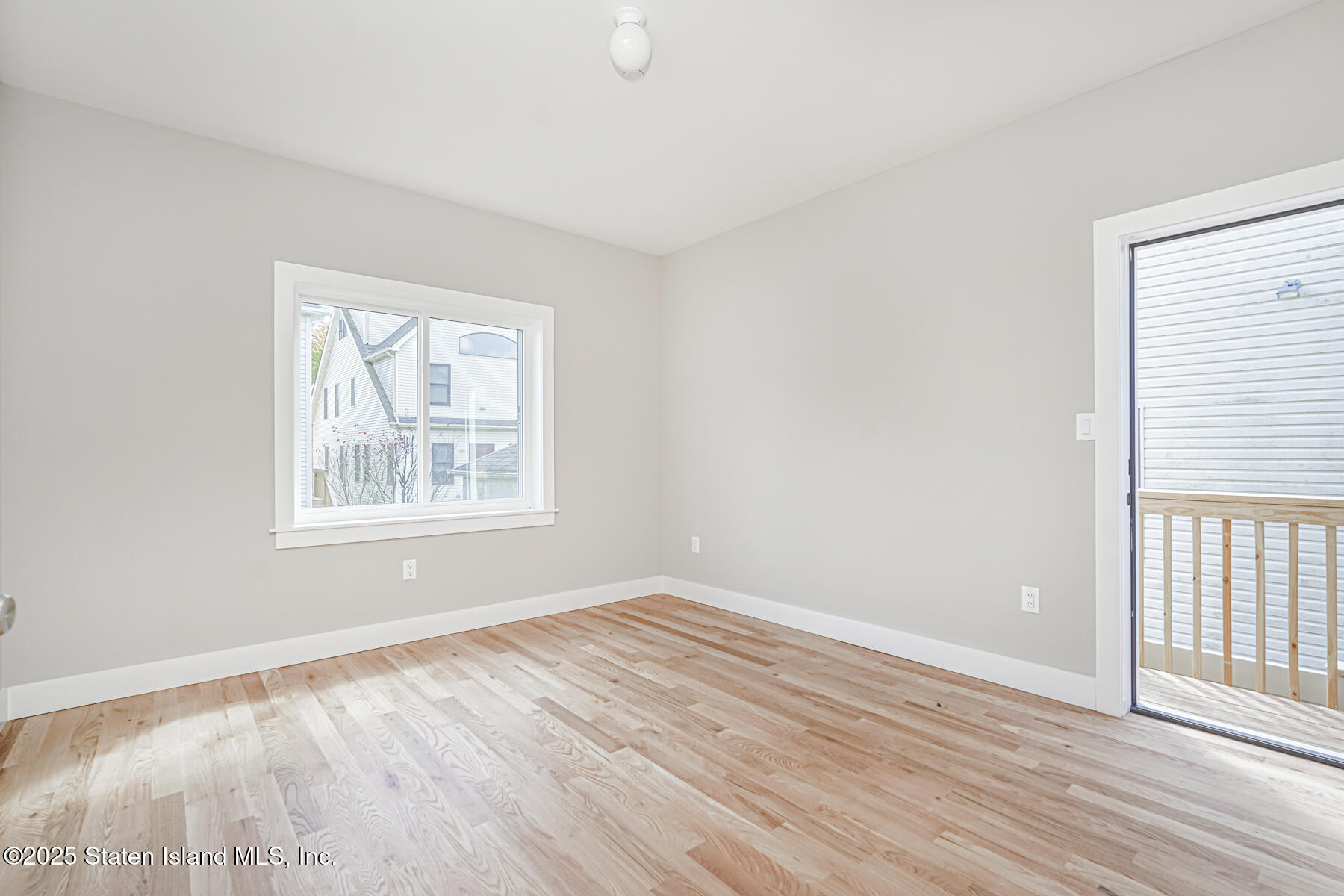 291 Rensselaer Avenue Staten Island, NY 10312 - Photo 27 of 38 an empty room with wooden floor and windows