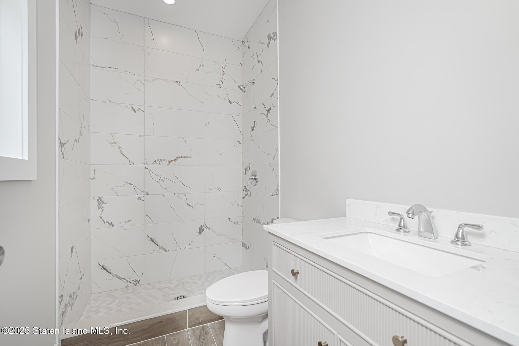 291 Rensselaer Avenue Staten Island, NY 10312 - Photo 28 of 38 a bathroom with a granite countertop sink toilet and shower