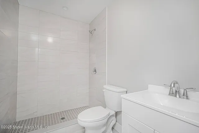 a white toilet sitting next to a bathroom sink