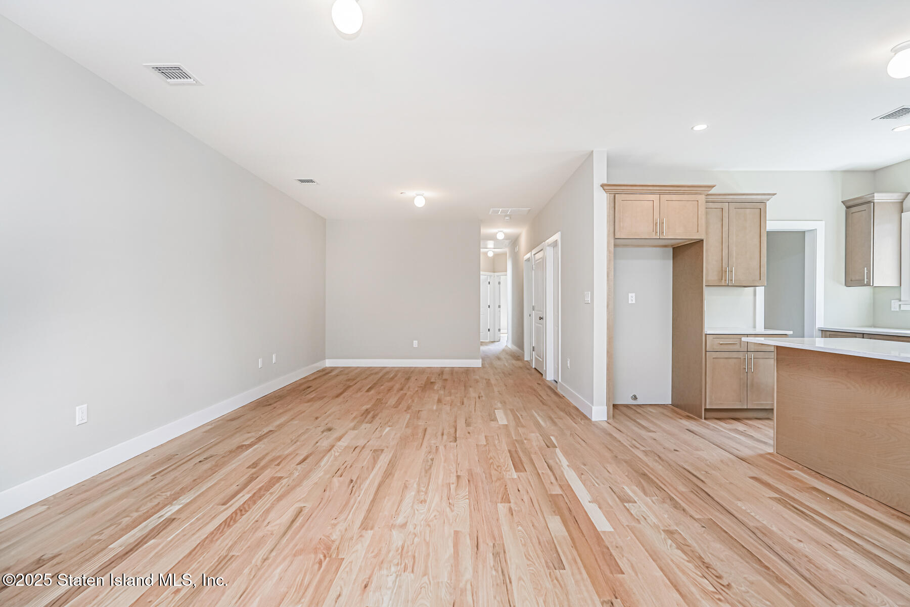 291 Rensselaer Avenue Staten Island, NY 10312 - Photo 4 of 38 a view of a room with wooden floor and a window
