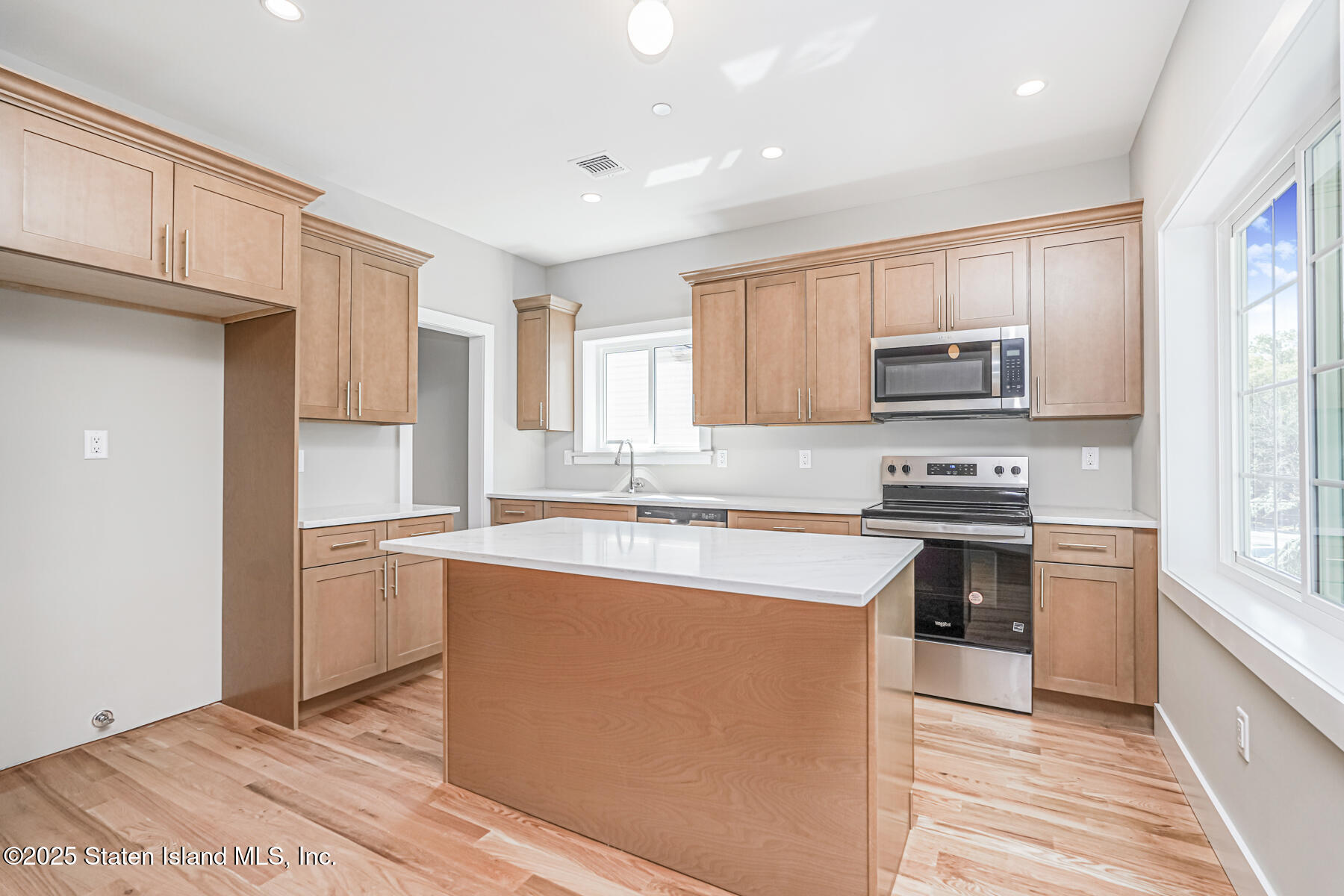 291 Rensselaer Avenue Staten Island, NY 10312 - Photo 5 of 38 a kitchen with stainless steel appliances granite countertop a stove a sink and a refrigerator