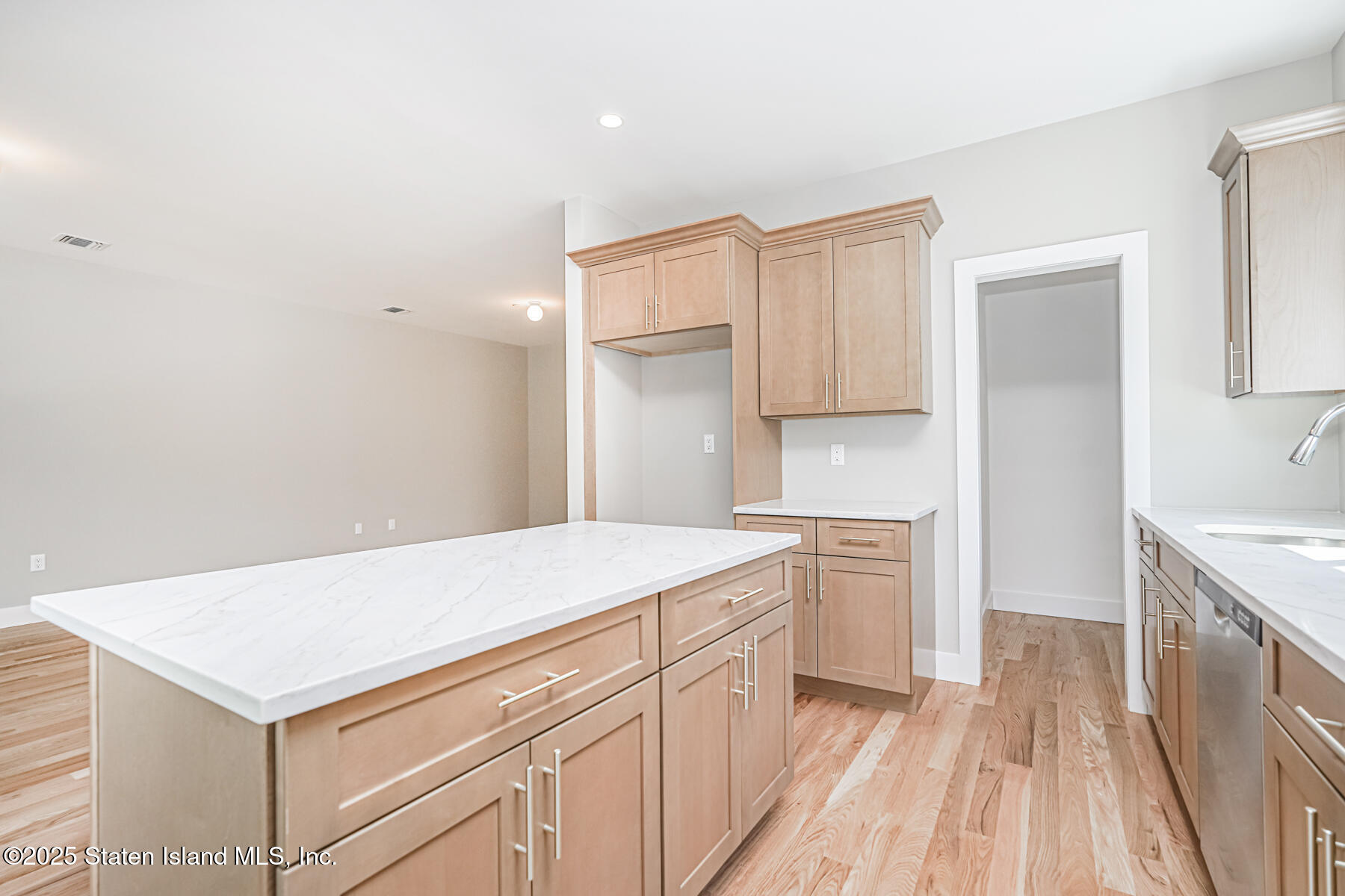 291 Rensselaer Avenue Staten Island, NY 10312 - Photo 6 of 38 a kitchen that has a sink a stove and wooden floor