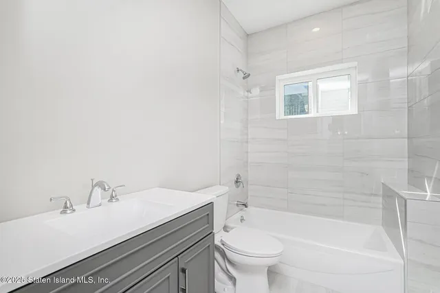 a bathroom with a sink a toilet and bathtub