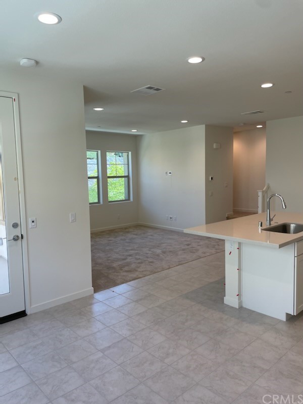 208 Winterbrook Lake Forest, CA 92610 - Photo 3 of 5 an empty room with kitchen and sink