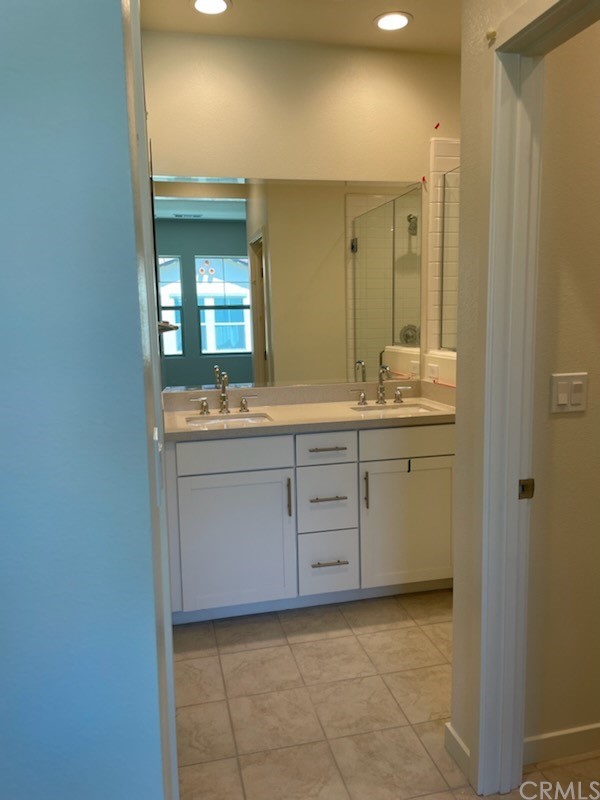 208 Winterbrook Lake Forest, CA 92610 - Photo 4 of 5 a bathroom with a sink a light fixture a vanity and a mirror