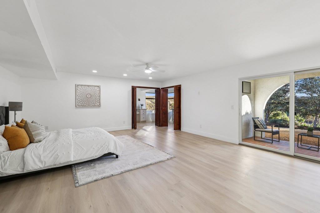 2865 Via Dieguenos Alpine, CA 91901 - Photo 32 of 75 a spacious bedroom with a bed and a large window