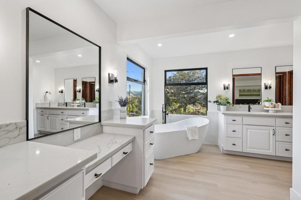 2865 Via Dieguenos Alpine, CA 91901 - Photo 36 of 75 a large bathroom with a large mirror vanity sink and bathtub