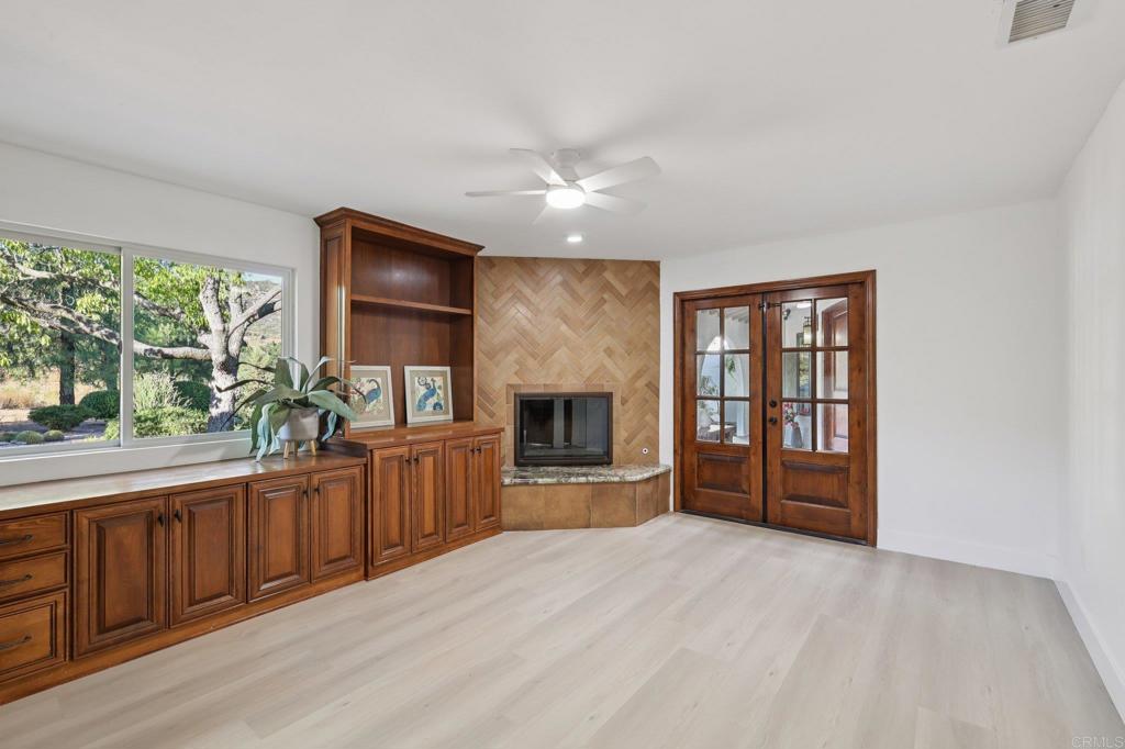 2865 Via Dieguenos Alpine, CA 91901 - Photo 46 of 75 wooden floor in an empty room with a fireplace and a window