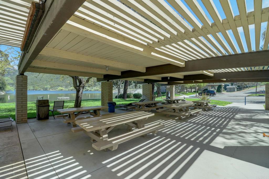 2865 Via Dieguenos Alpine, CA 91901 - Photo 69 of 75 a view of a patio with table and chairs with wooden floor and fence