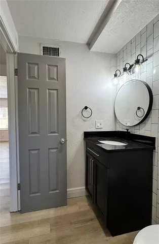 a bathroom with a sink a vanity and a mirror