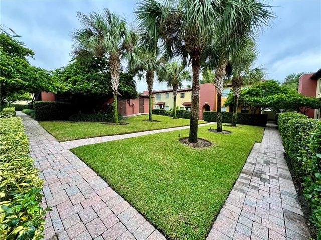 a couple of potted plants in front of door
