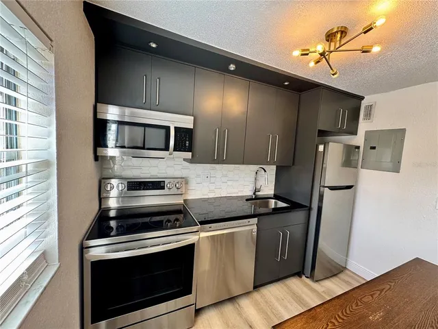 a kitchen with a stove and a microwave