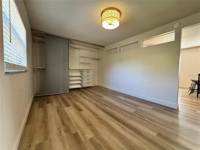a view of a room with wooden floor