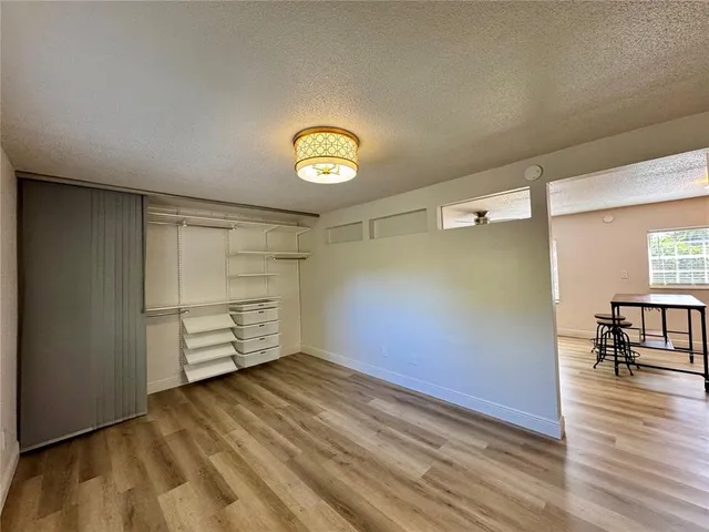 a view of empty room with wooden floor