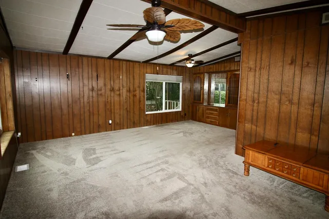 a kitchen with a table chairs sink and cabinets