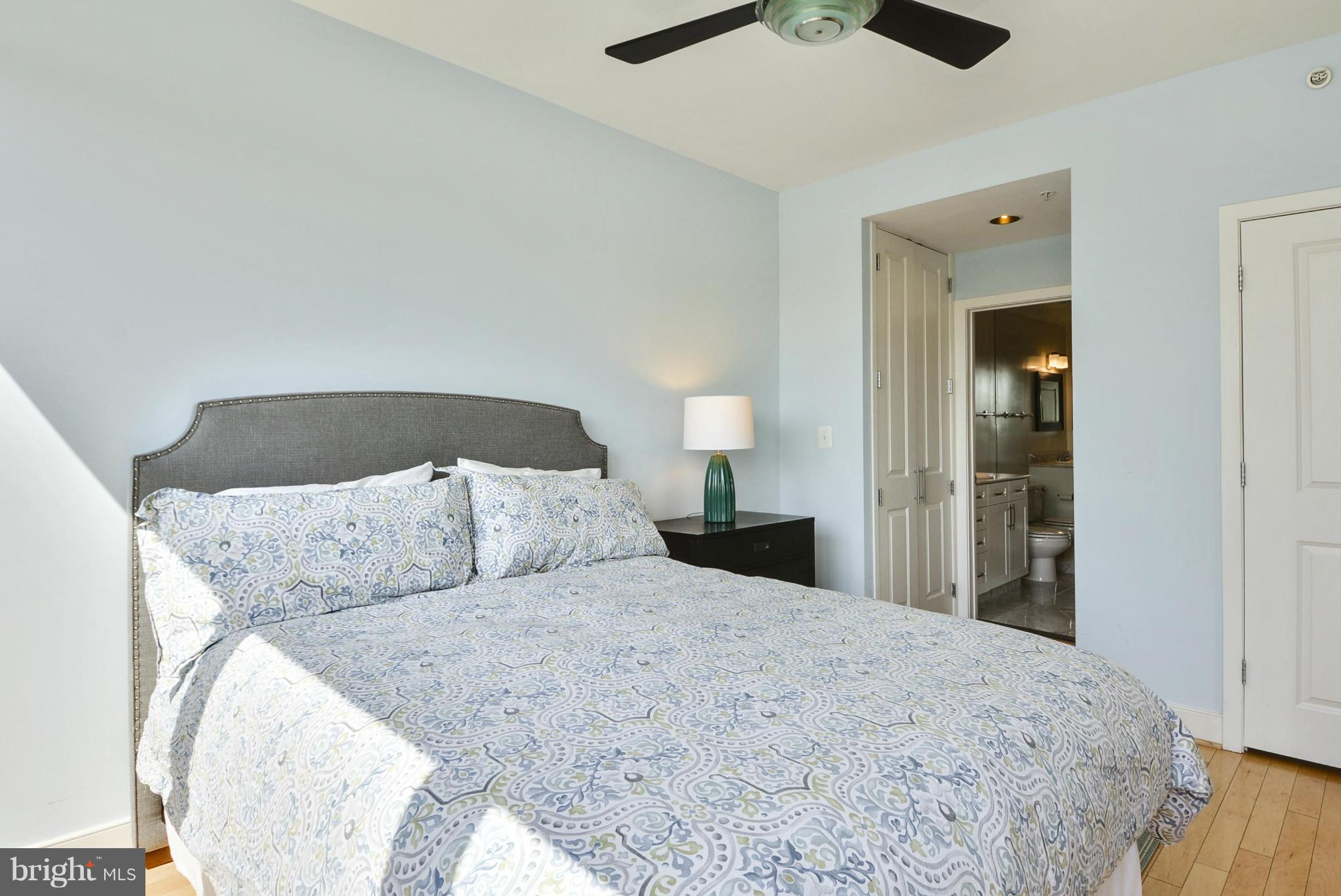 4101 Albemarle Street Northwest, Unit 337 Washington, DC 20016 - Photo 12 of 30 a bed room with a bed and a chandelier