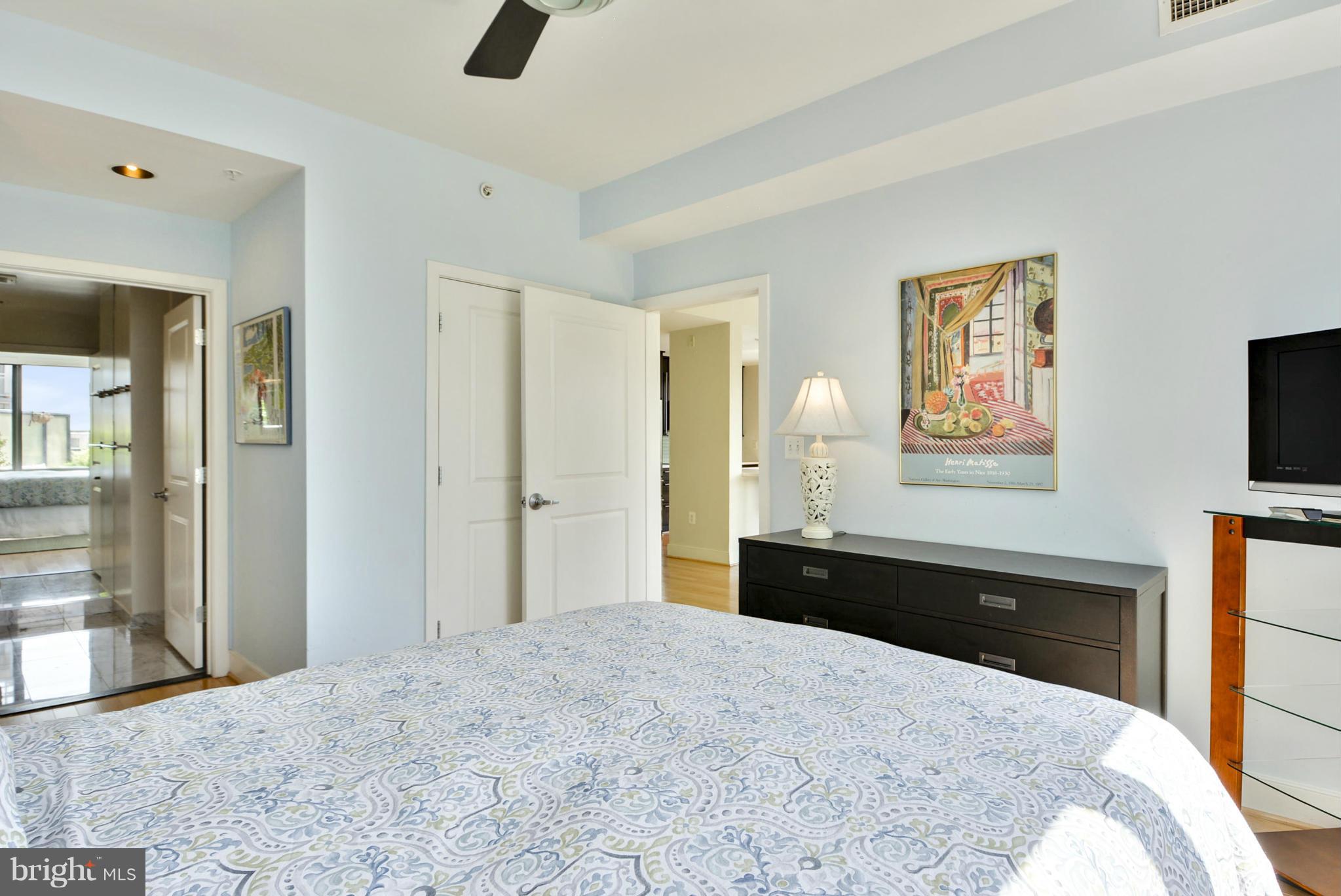 4101 Albemarle Street Northwest, Unit 337 Washington, DC 20016 - Photo 13 of 30 a bedroom with a bed and a flat tv screen on dresser
