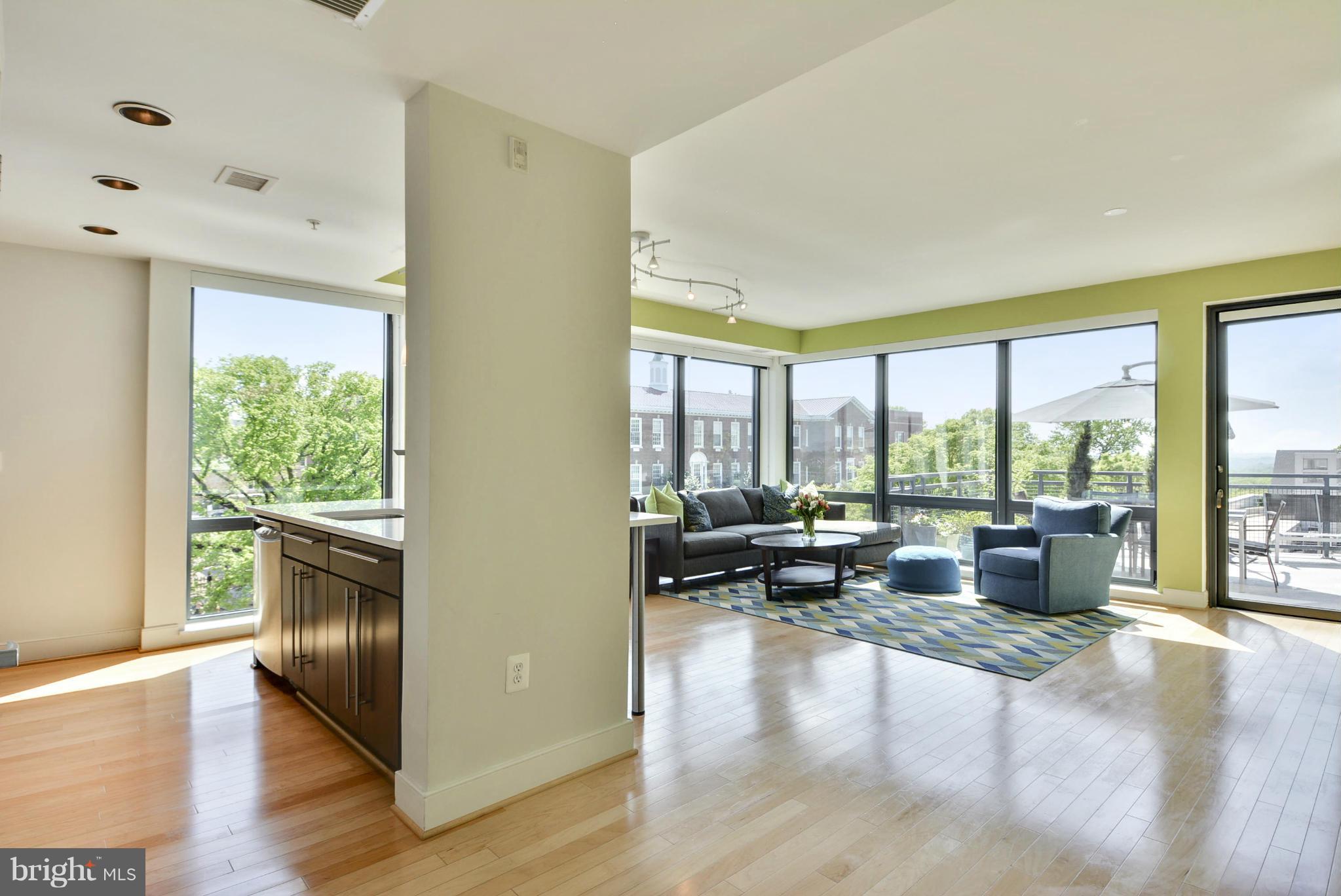 4101 Albemarle Street Northwest, Unit 337 Washington, DC 20016 - Photo 2 of 30 a living room with furniture and large windows