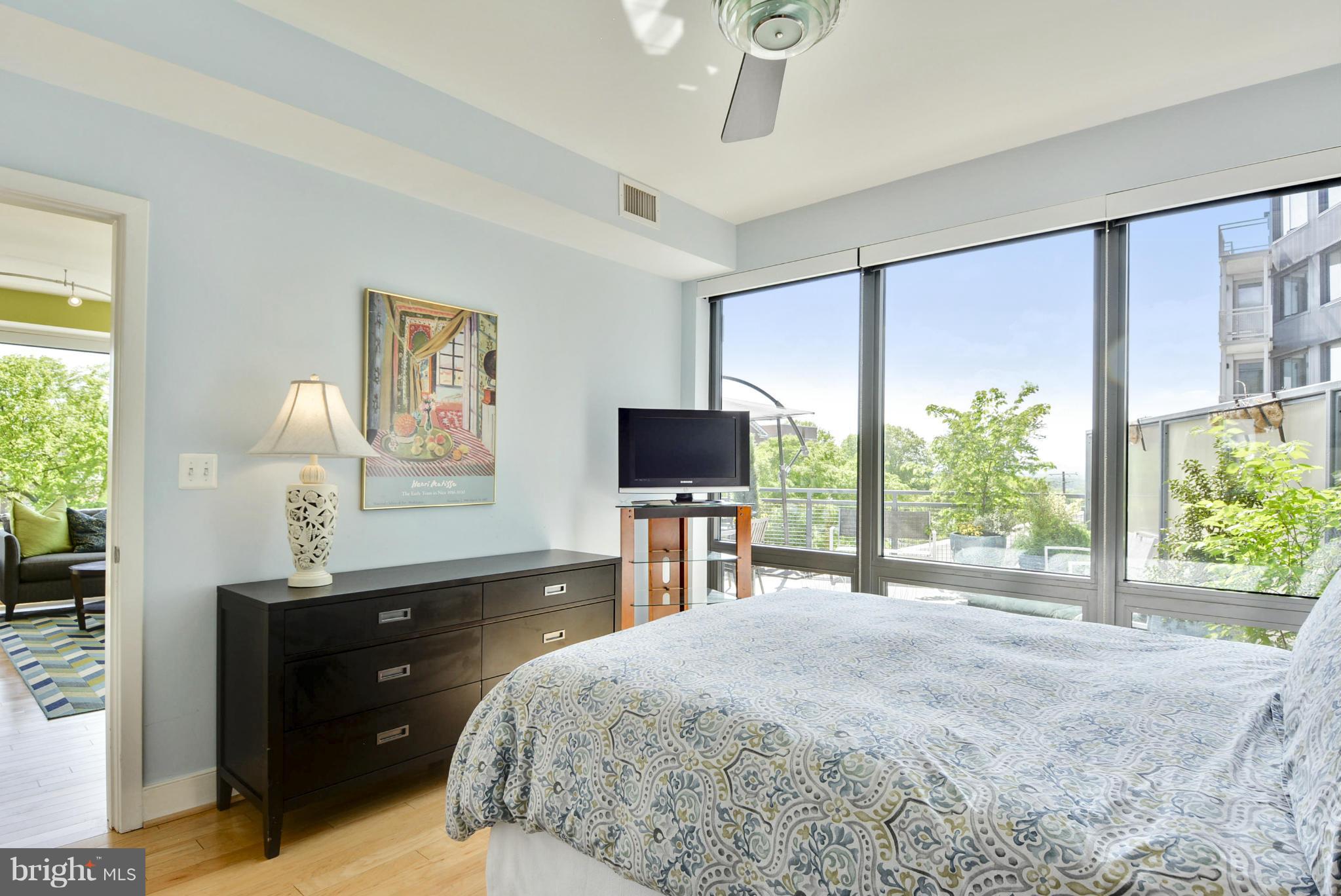 4101 Albemarle Street Northwest, Unit 337 Washington, DC 20016 - Photo 10 of 30 a bedroom with a bed and a flat screen tv