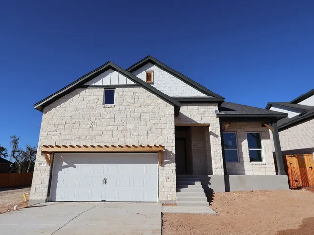 a front view of a house with a garage