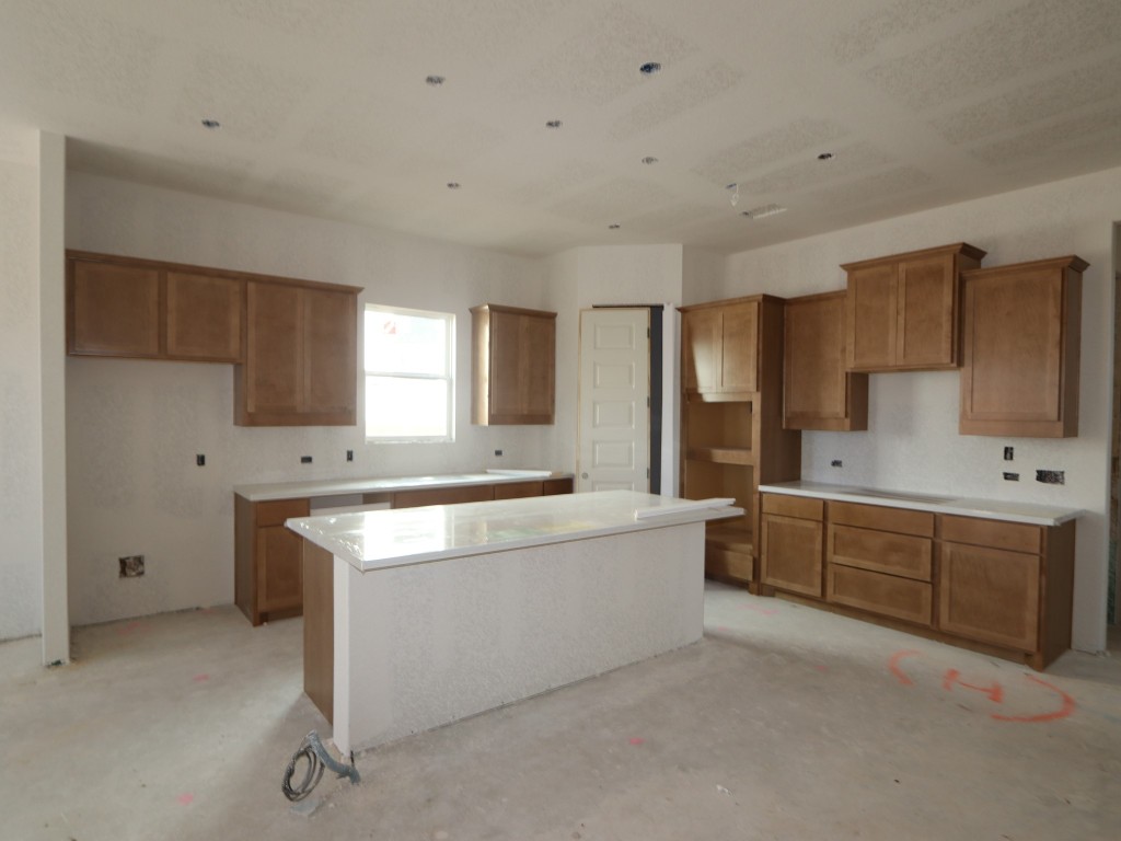 350 Bishop Wood Road Dripping Springs, TX 78620 - Photo 11 of 17 a large white kitchen with a stove a sink dishwasher and a refrigerator