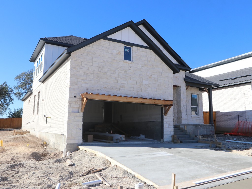 350 Bishop Wood Road Dripping Springs, TX 78620 - Photo 2 of 17 a front view of a house with a yard