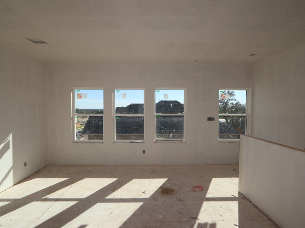 350 Bishop Wood Road Dripping Springs, TX 78620 - Photo 6 of 17 a view of an empty room with a window