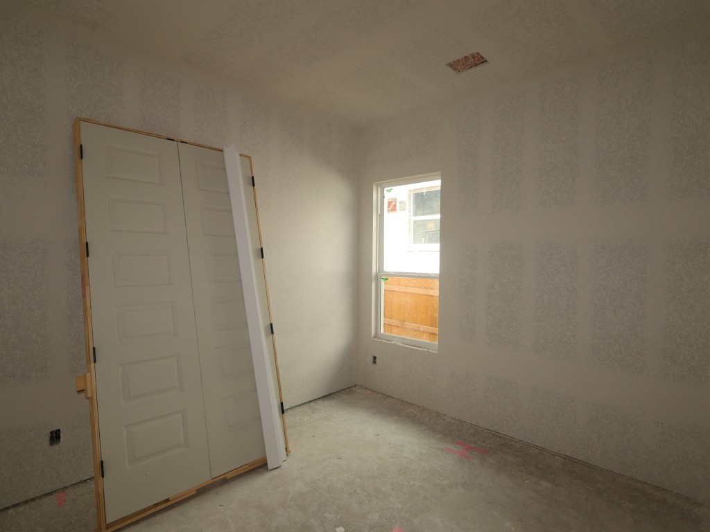 350 Bishop Wood Road Dripping Springs, TX 78620 - Photo 8 of 17 an empty room with windows