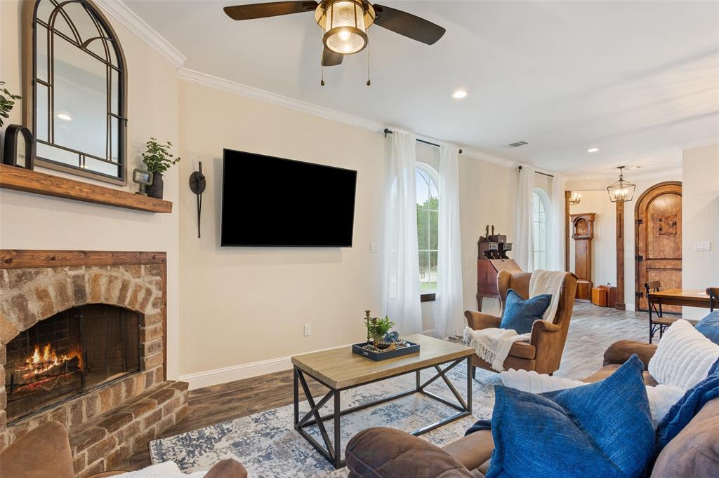 566 Benevolence Way China Spring, TX 76633 - Photo 11 of 35 a living room with furniture a flat screen tv and a fireplace