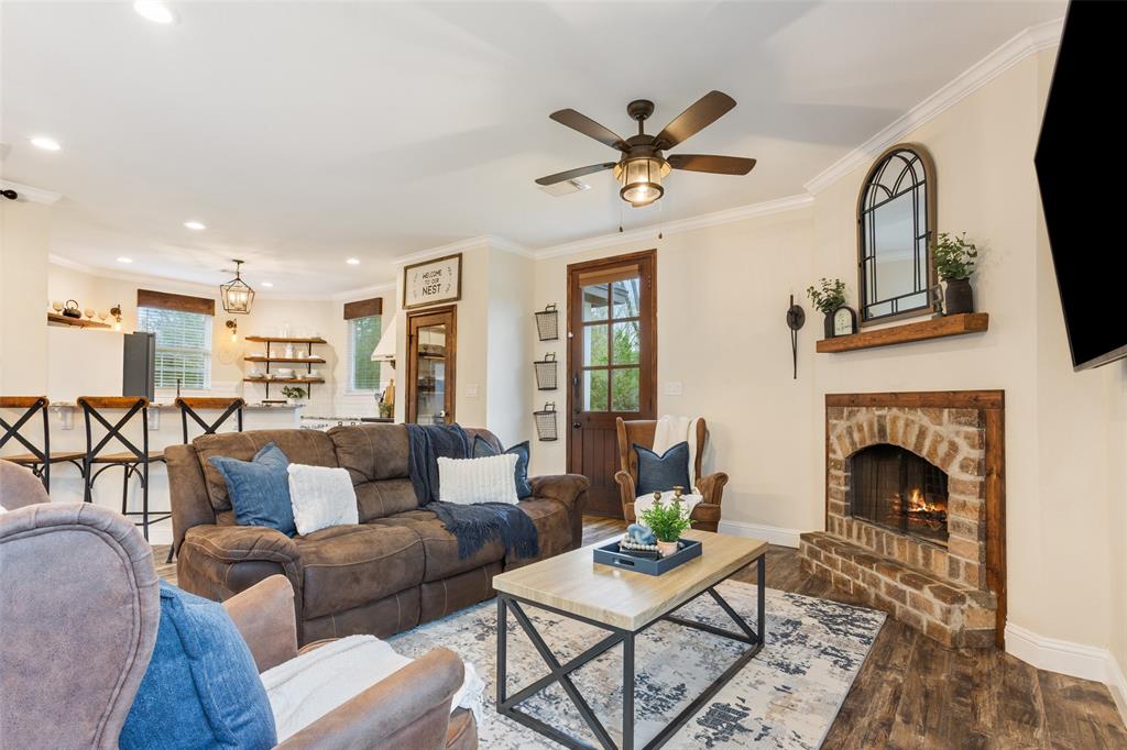 566 Benevolence Way China Spring, TX 76633 - Photo 12 of 35 a living room with furniture a fireplace and a flat screen tv