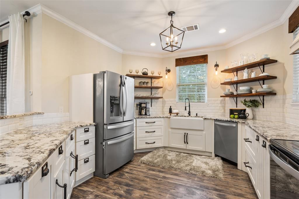 566 Benevolence Way China Spring, TX 76633 - Photo 14 of 35 a kitchen with stainless steel appliances granite countertop a refrigerator and a stove top oven