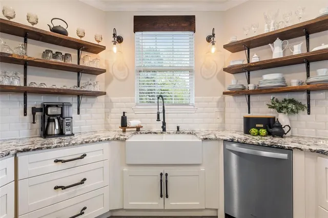 a kitchen with stainless steel appliances a sink and cabinets