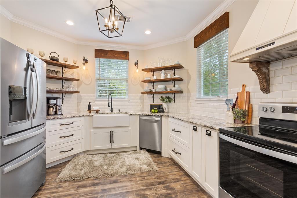 566 Benevolence Way China Spring, TX 76633 - Photo 16 of 35 a kitchen with stainless steel appliances kitchen island granite countertop a stove a sink and a refrigerator