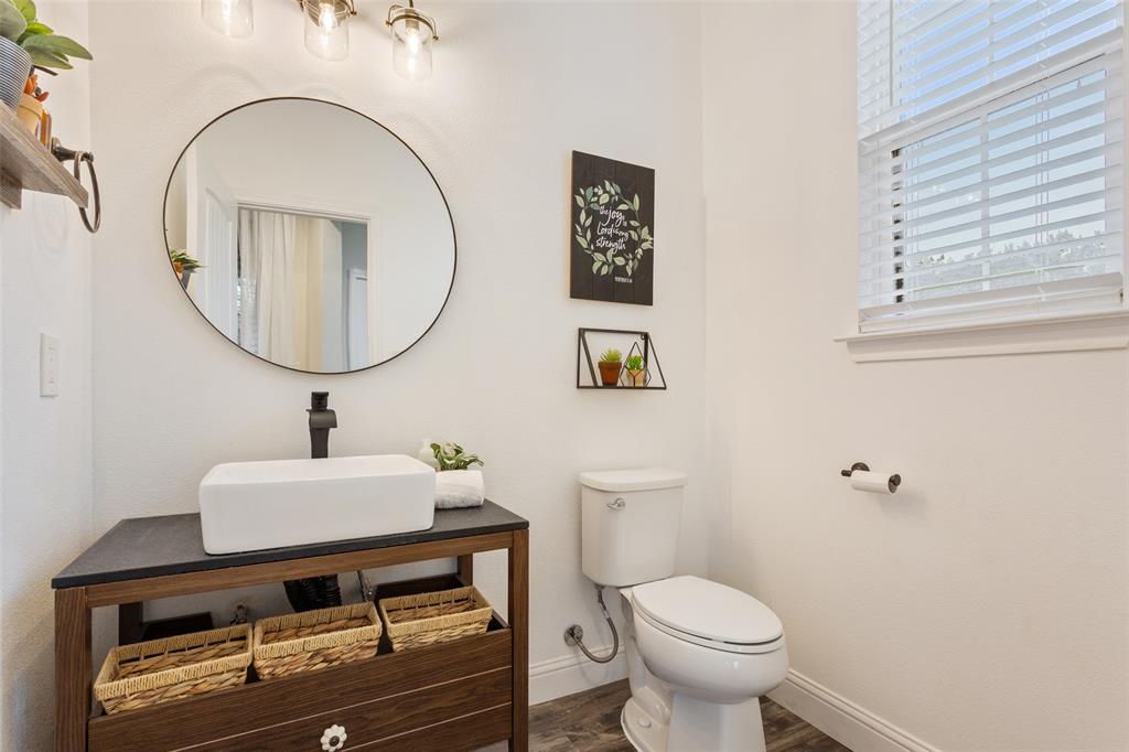 566 Benevolence Way China Spring, TX 76633 - Photo 18 of 35 a bathroom with a sink mirror and toilet