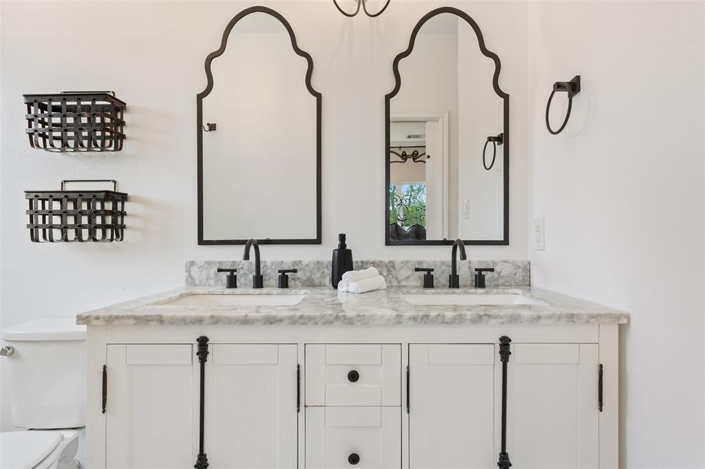 566 Benevolence Way China Spring, TX 76633 - Photo 21 of 35 a bathroom with a double vanity sink and a mirror